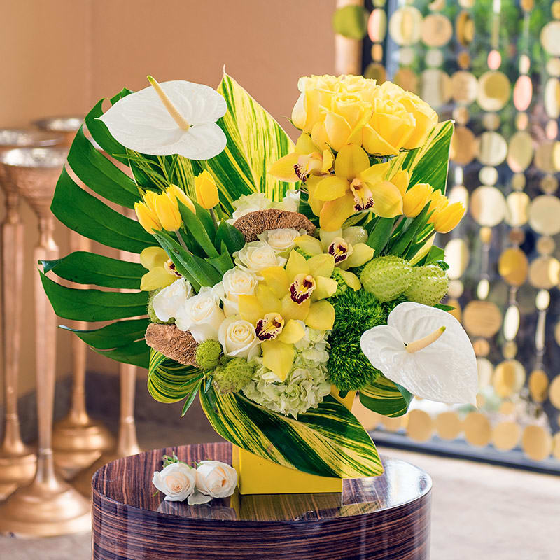 This bright arrangement of calla lilies, orchids, tulips, and more is a