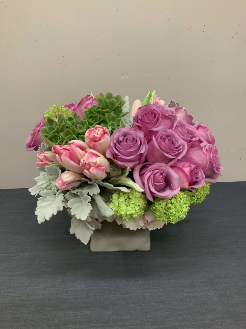 An arrangement with roses, tulips, succulents, and beautiful greenery. For a special