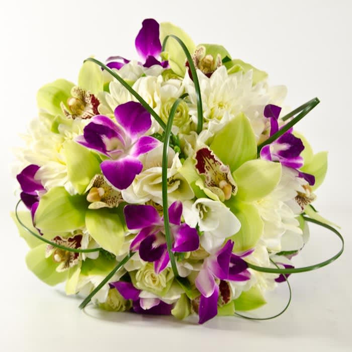 A exquisite blend of green cymbidium orchid, white freesia, white roses, white