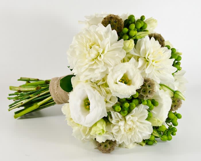 A natural hand tied of white hydrangeas, dahlias, lisianthus, accent with green