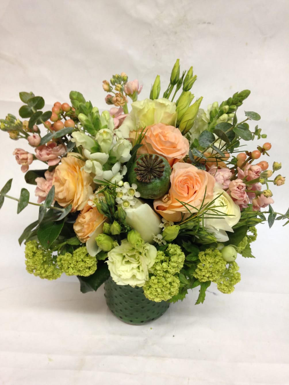 This pastel beauty is a lush treat, featuring peach roses,spray roses, stock