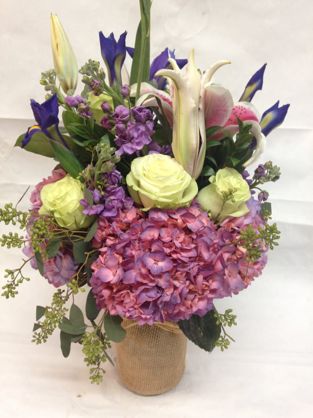 This fresh arrangement features the sights and smells of early summer: hydrangea