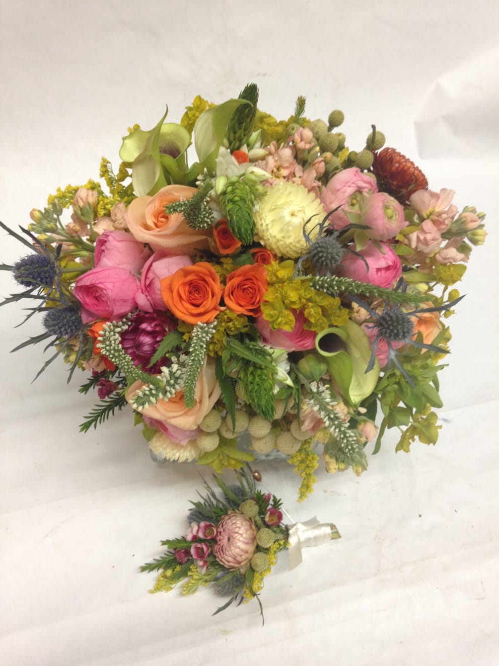 This bouquet and boutonniere is filled with sweet, fresh flowers with a