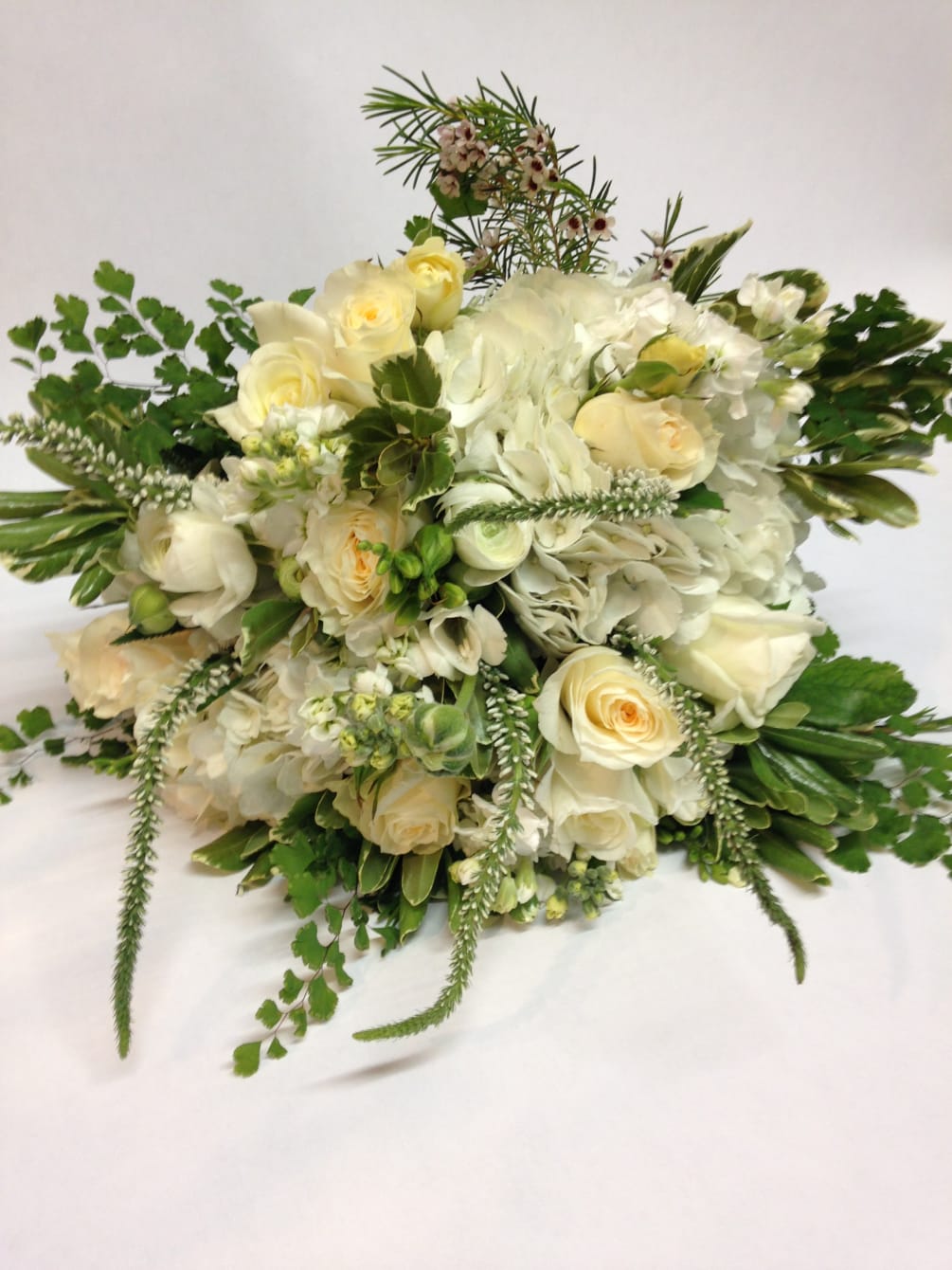 This lush and fragrant bridal bouquet includes white garden roses, stock, veronica
