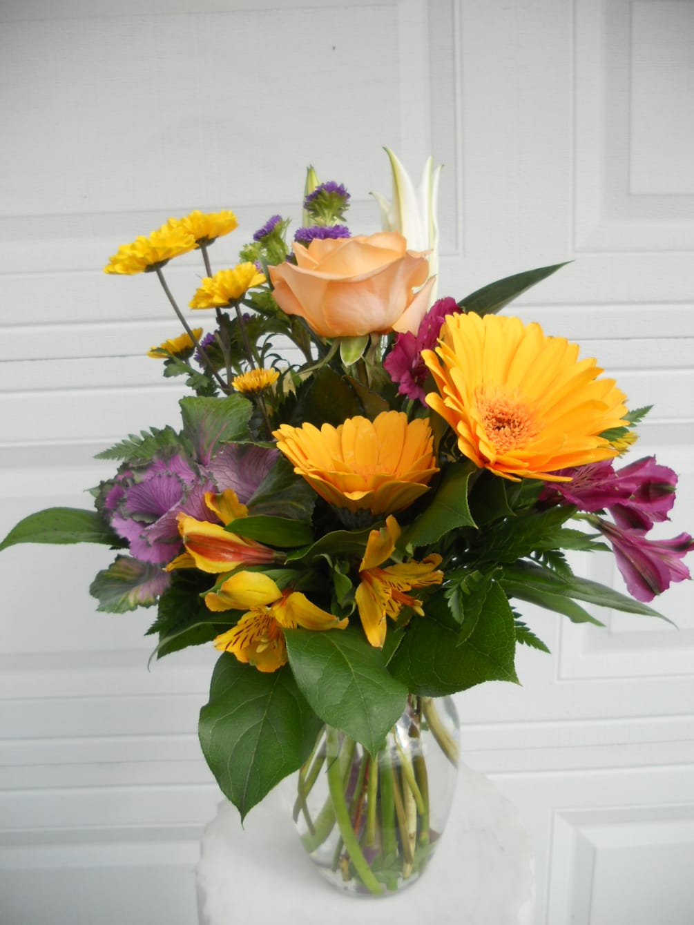 Mixture of seasonal autumn flowers in fall colors. Flowers can vary but