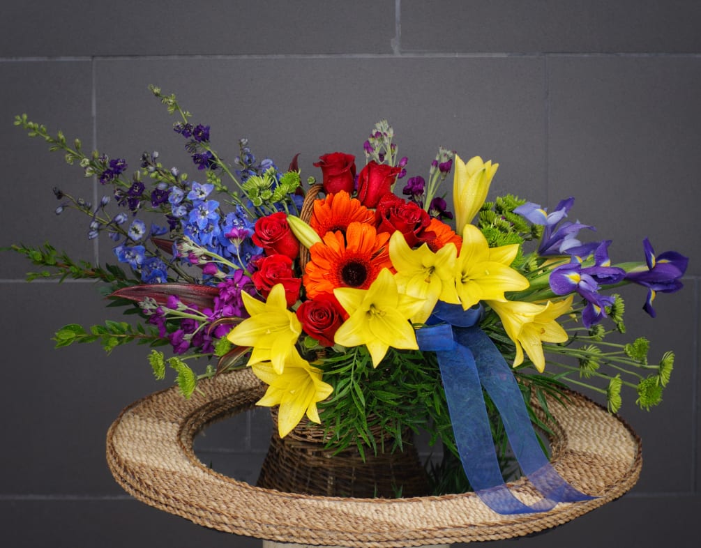 Rainbow blooms symbolize peace and serenity. This design includes rose, lily, gerbera