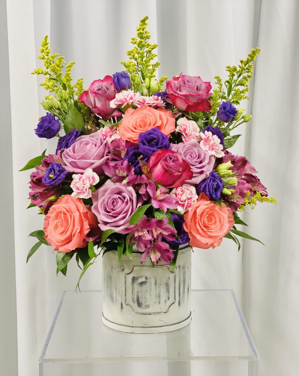 This bright, airy, and colorful floral design is sure to give you