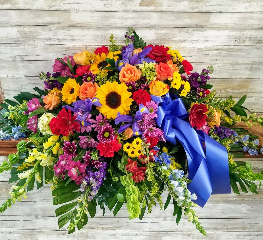Celebrate their life with a bright bold spray of fresh flowers. 