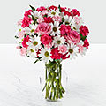 Our Sweet Surprises Bouquet includes white daisies; hot pink &amp; pale pink