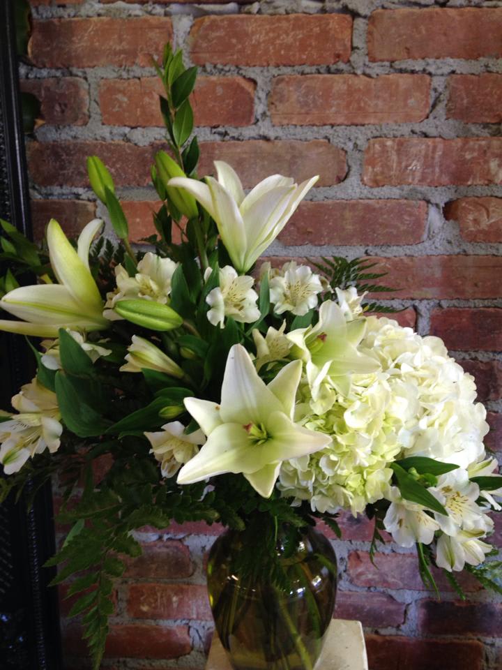 Sea of white flowers includes roses, hydrangeas, alstromaria, lillies, larkspur and leather