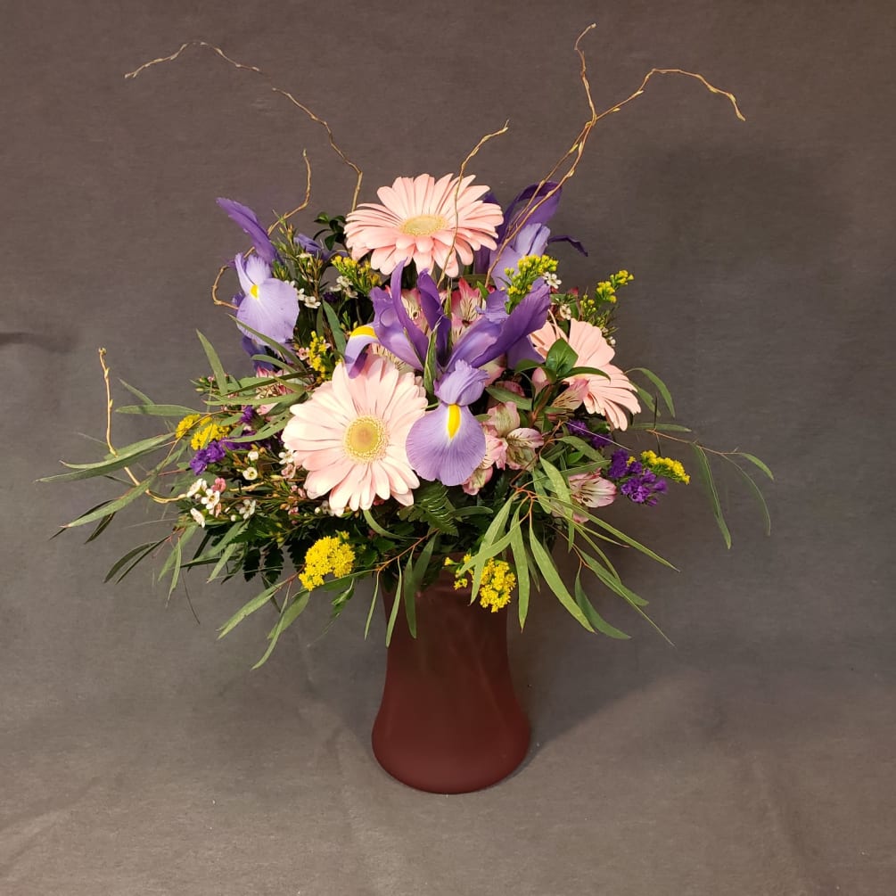 This vase is full of gerbera daisies, and other beautiful mixed florals.