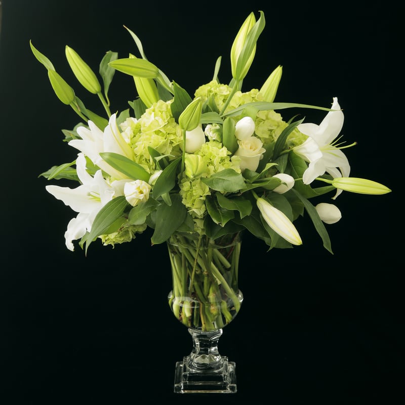 A beautiful classic arrangement of white lilies, green and white hydrangeas, white