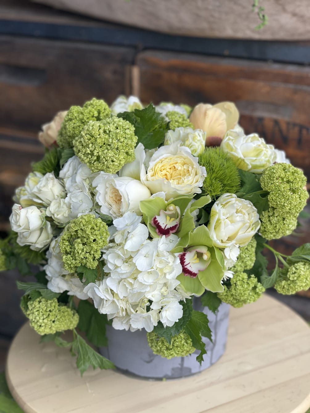Timeless green and white signature arrangement filled with viburnum and white hydrangea