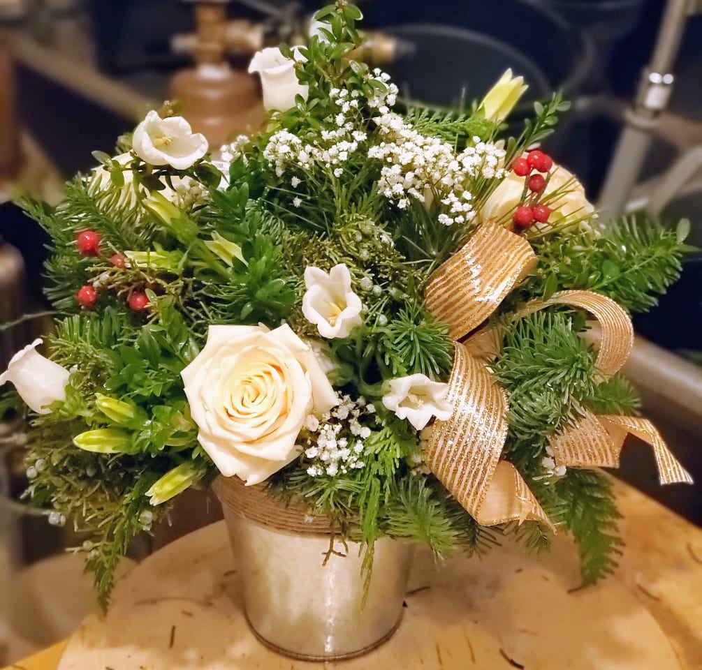 Modern floral design winter greens with fresh blooms elaborated with modern design