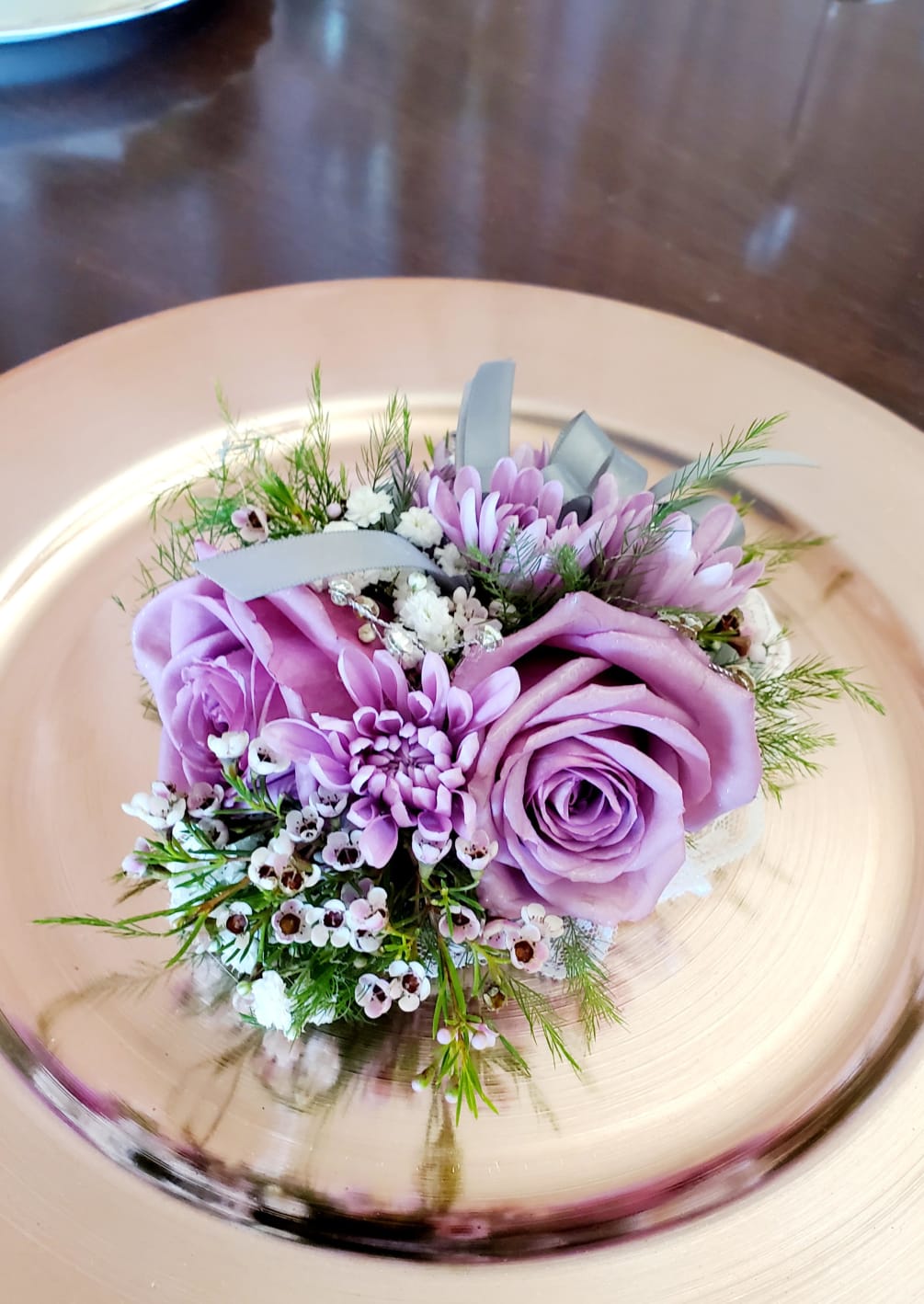 Lavender roses, purple wax flower and baby&#039;s breath wrist corsage.