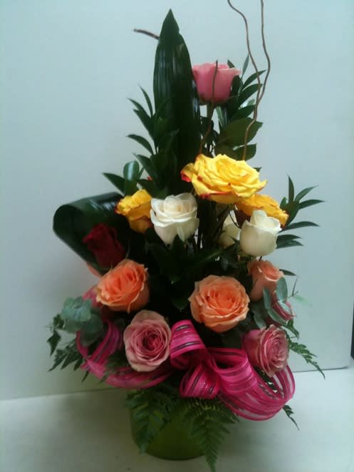 Combination of roses in different colors. Arrangement designed on one side
