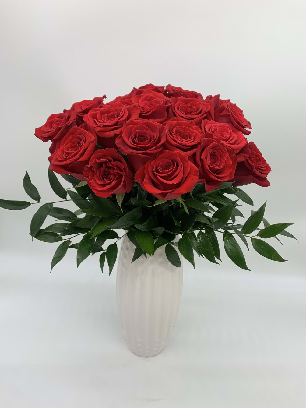 This Arrangement contains 24 Red Roses with a ceramic base with 16