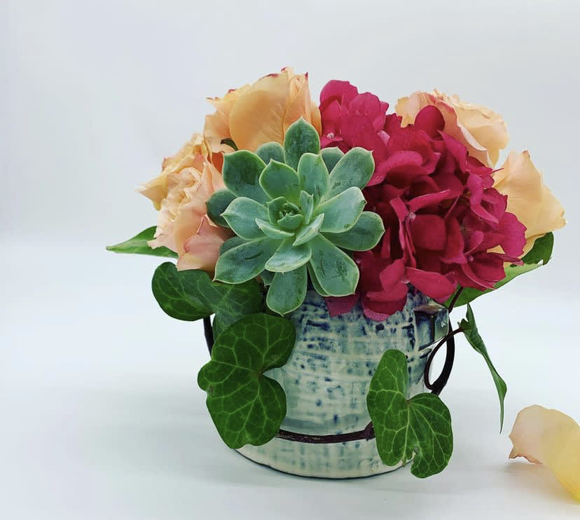 Roses, hydrangea, succulent and a touch if Ivy 
Ceramic Vase 4x4 
