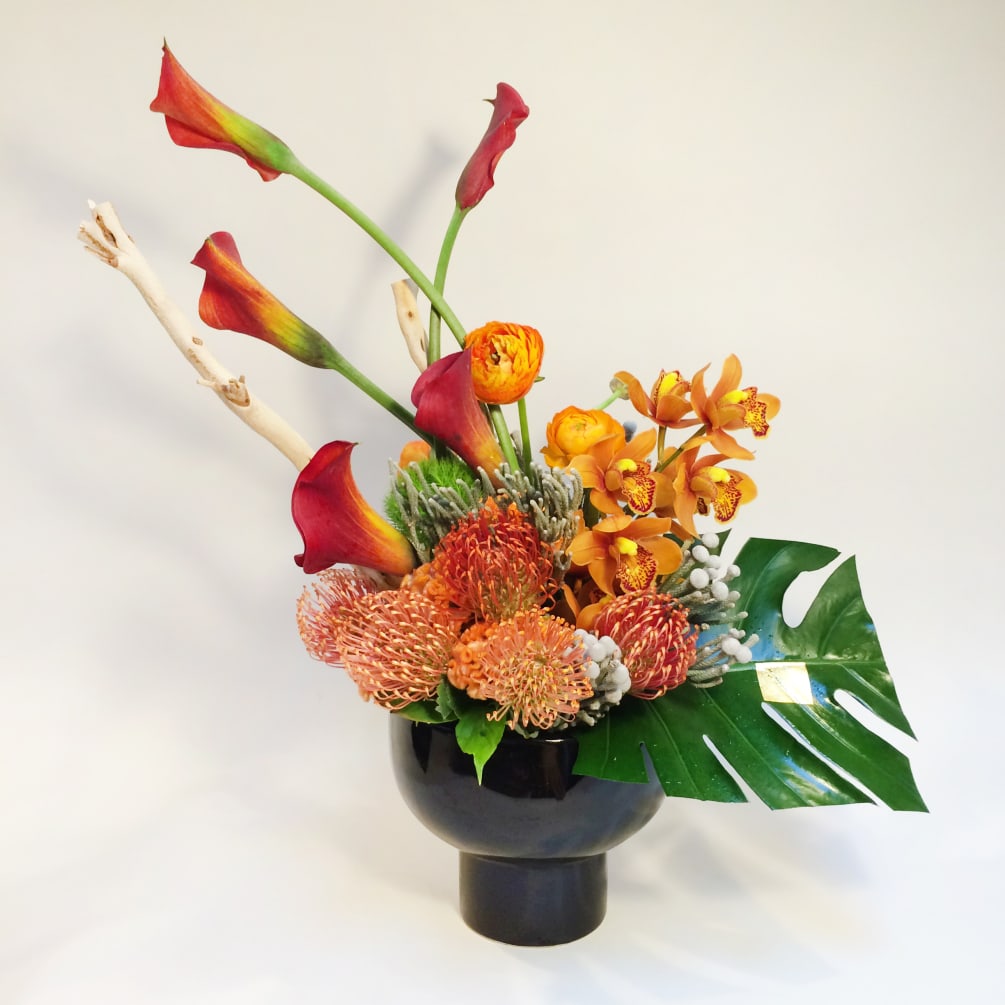 A modern, tall and compact arrangement with all tones of amber. Comprised