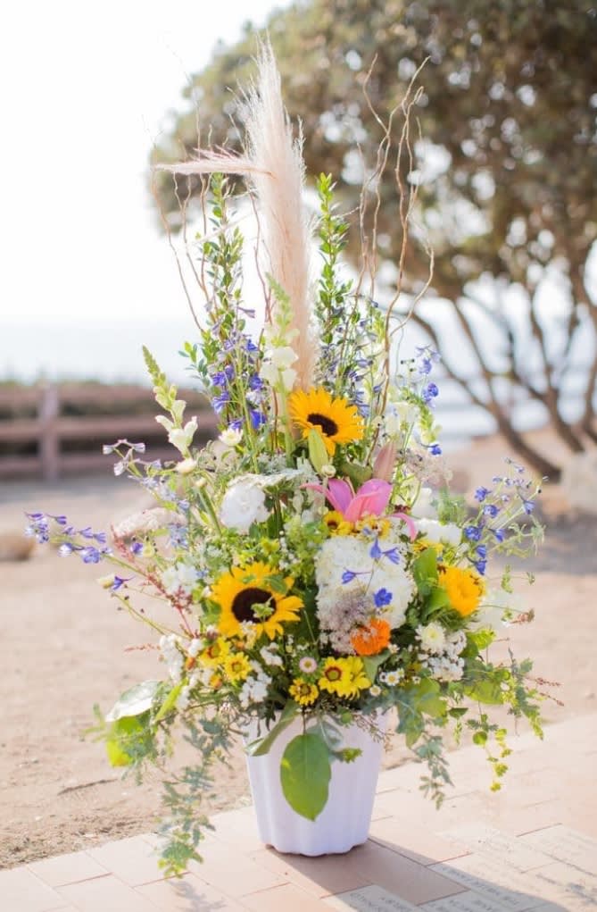 Extravagant arrangement filled with variety of wildflowers. 