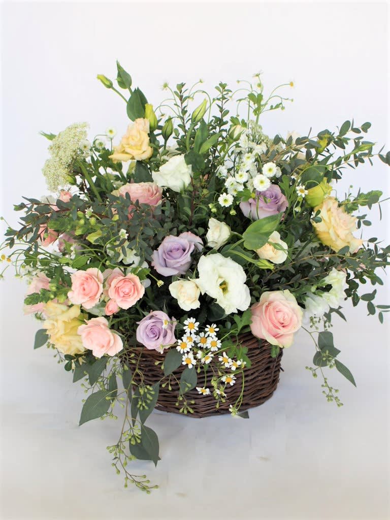 Large vase or basket with natural looking arrangement.