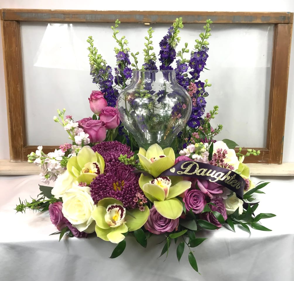 Urn Surround with purple larkspur framing the back, lavender roses, green orchids