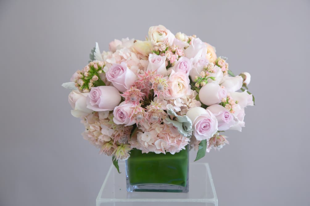 A beautiful mix of premium roses wrapped in green leaves. Soft pinks