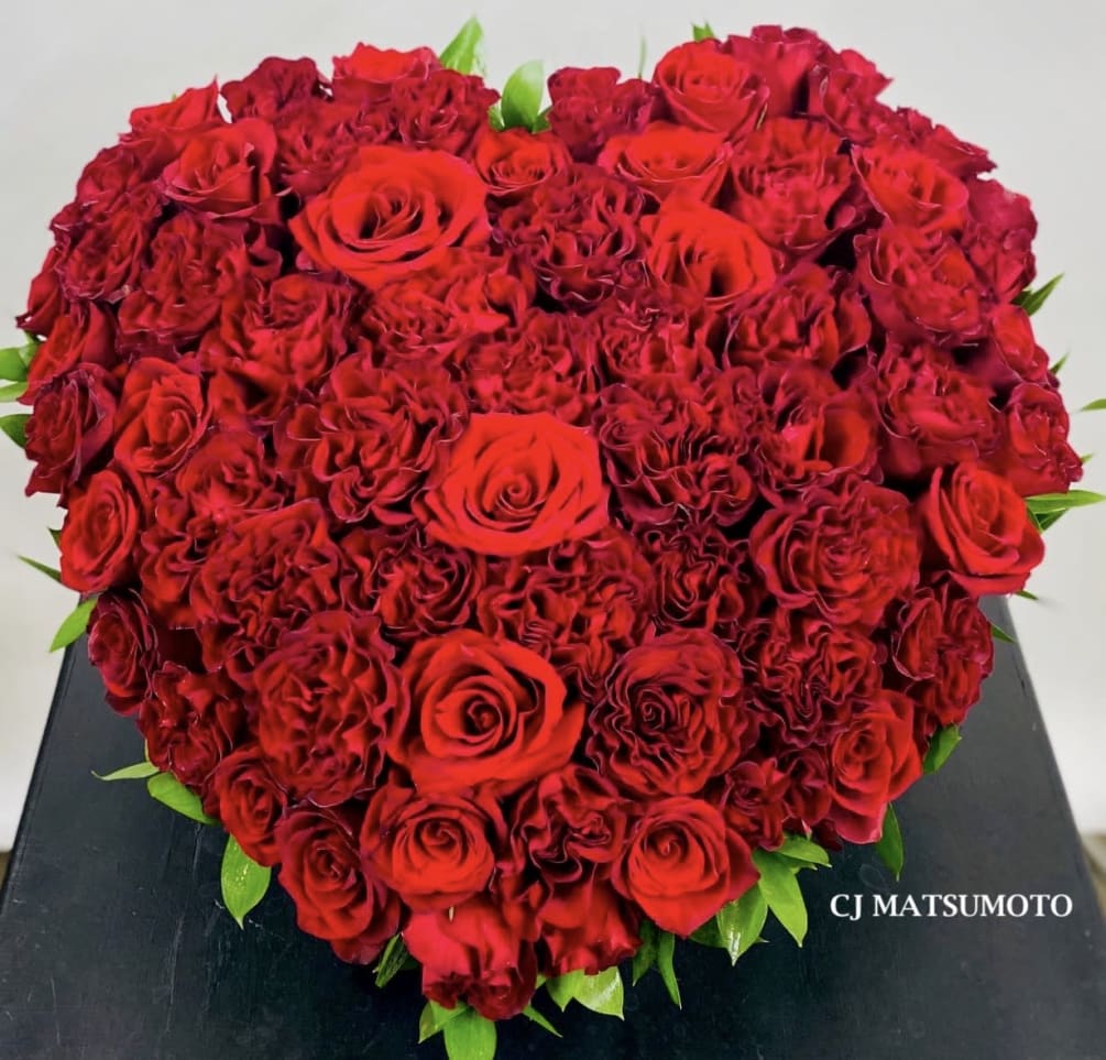 One heartfelt arrangement of textured red roses in a heart shape.