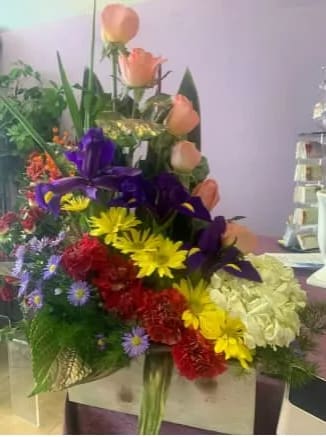 A modern array of roses, iris, daisies, carnations and a hydrangea