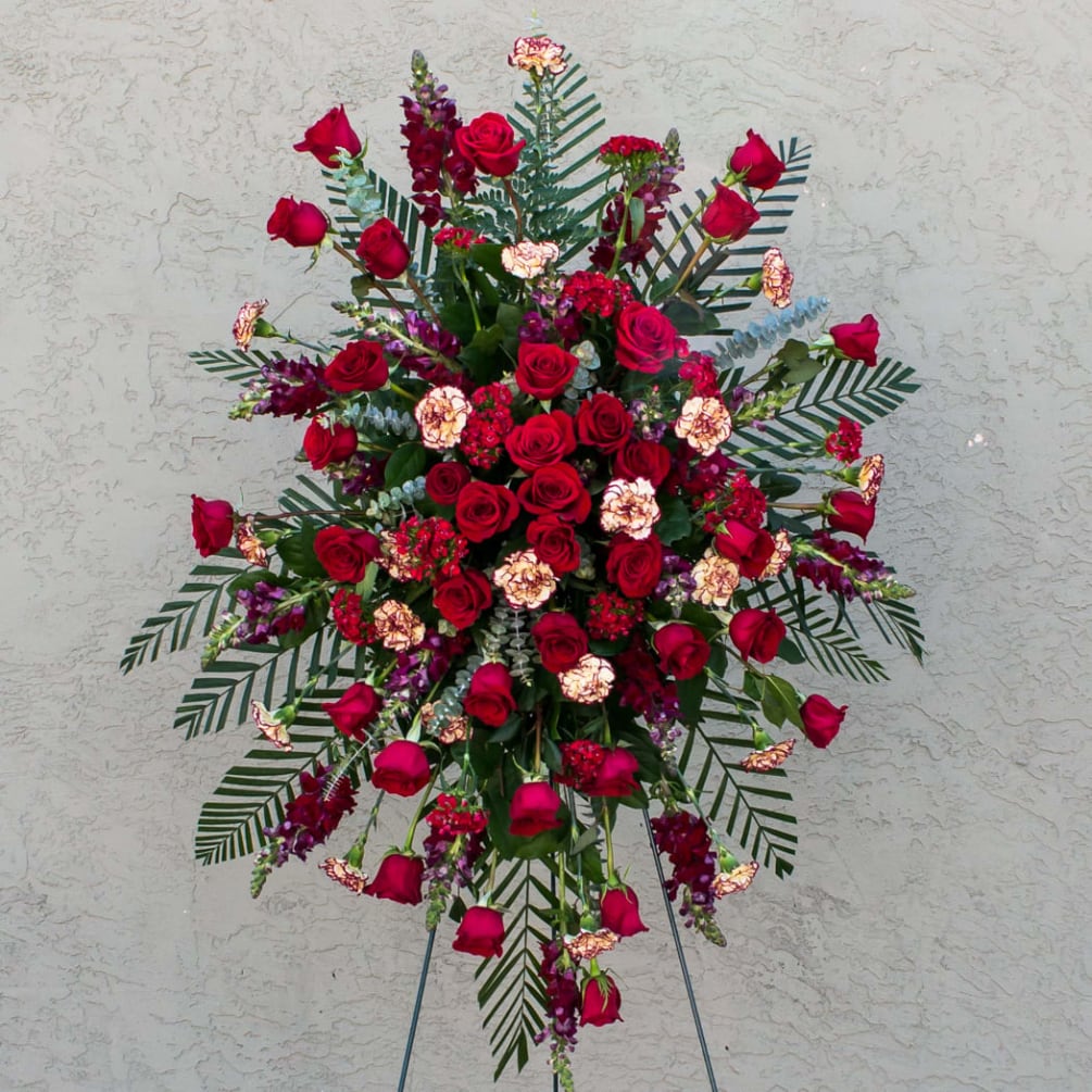 OUR ETERNAL LOVE STANDING SPRAY comes with red roses, carnations, snapdragons, sweet