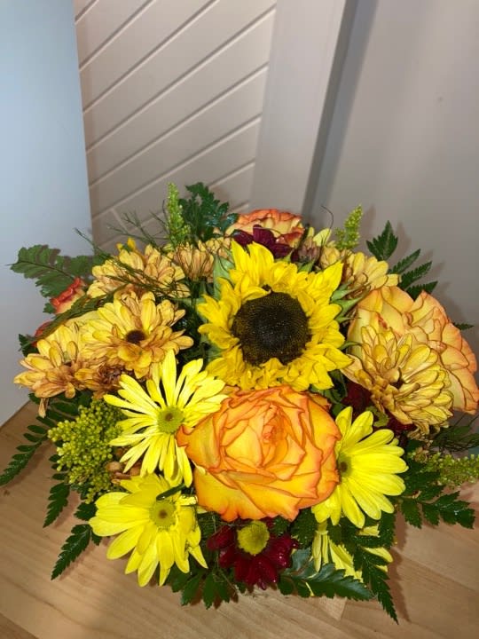 Greet the new season with this heartwarming sunflower and rose bouquet, presented