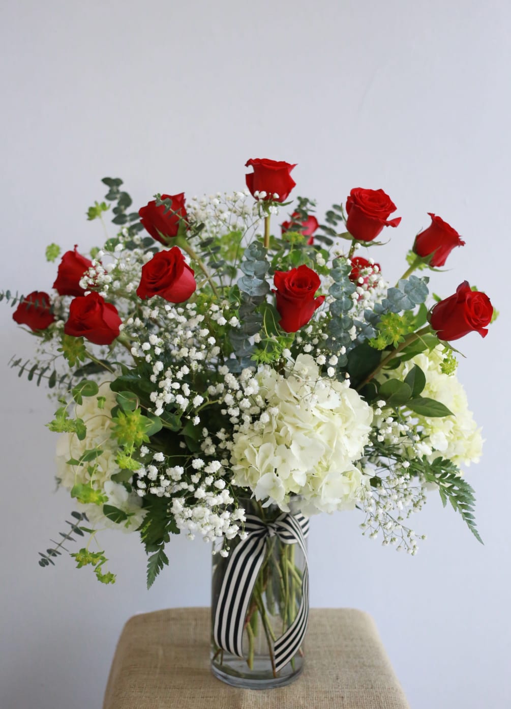 1 Dozen premium long stemmed roses, 4 beautiful large white hydrangeas, designed
