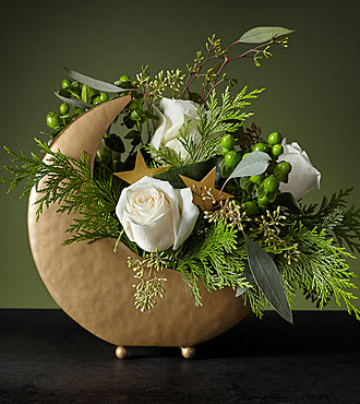 GOLDEN MOON AND STARS ARRANGEMENT WITH EVERGREENS, WHITE ROSES AND GREEN BERRIES