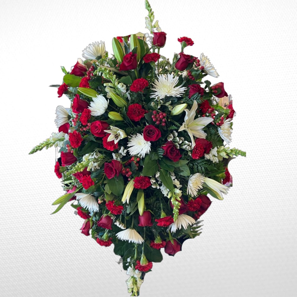 A red and white standing spray consisting of hypericum berries, disbuds, carnations