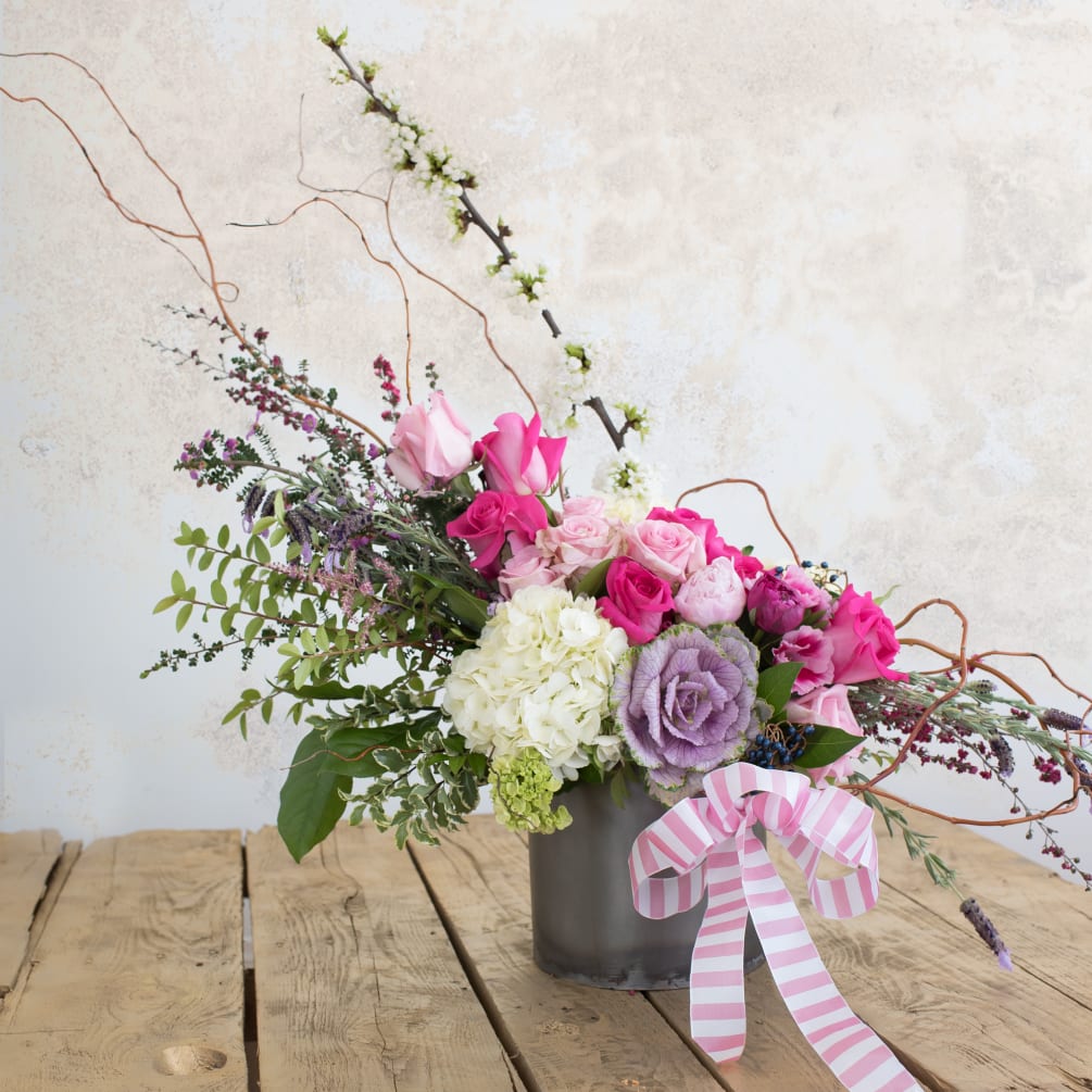 Beautiful arrangement filled with a variety of pink roses, peonies, hydrangeas, and