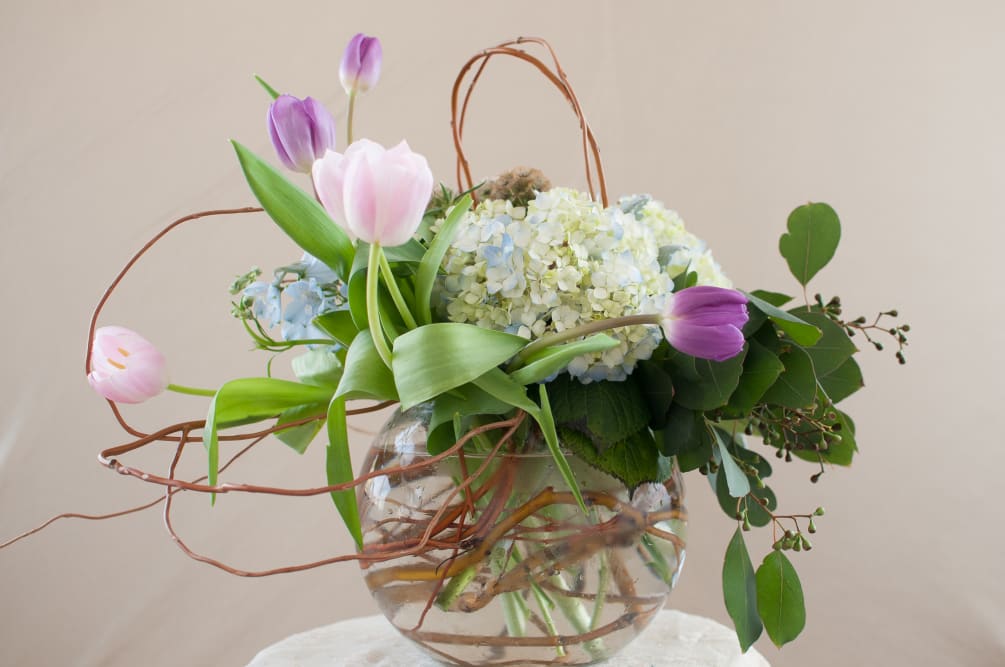This whimsical arrangement looks like springtime is in the air with pastel