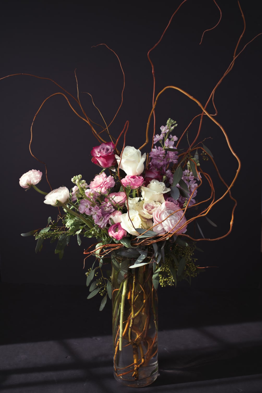 A romantic piece filled with delicate ranunculus, and an array of shades