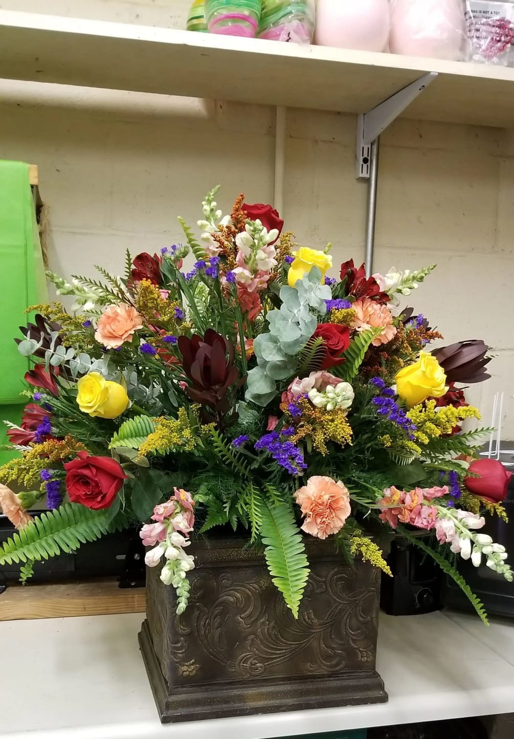 A full and big arrangement of mixed flowers for the center of
