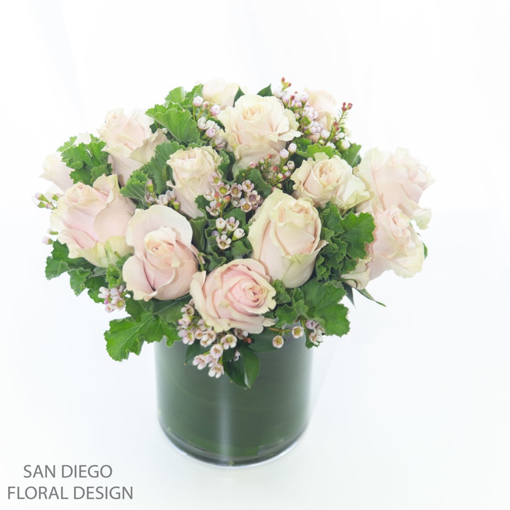 Blush Ecuadorian roses arranged in a leaf wrapped vase accented by premium