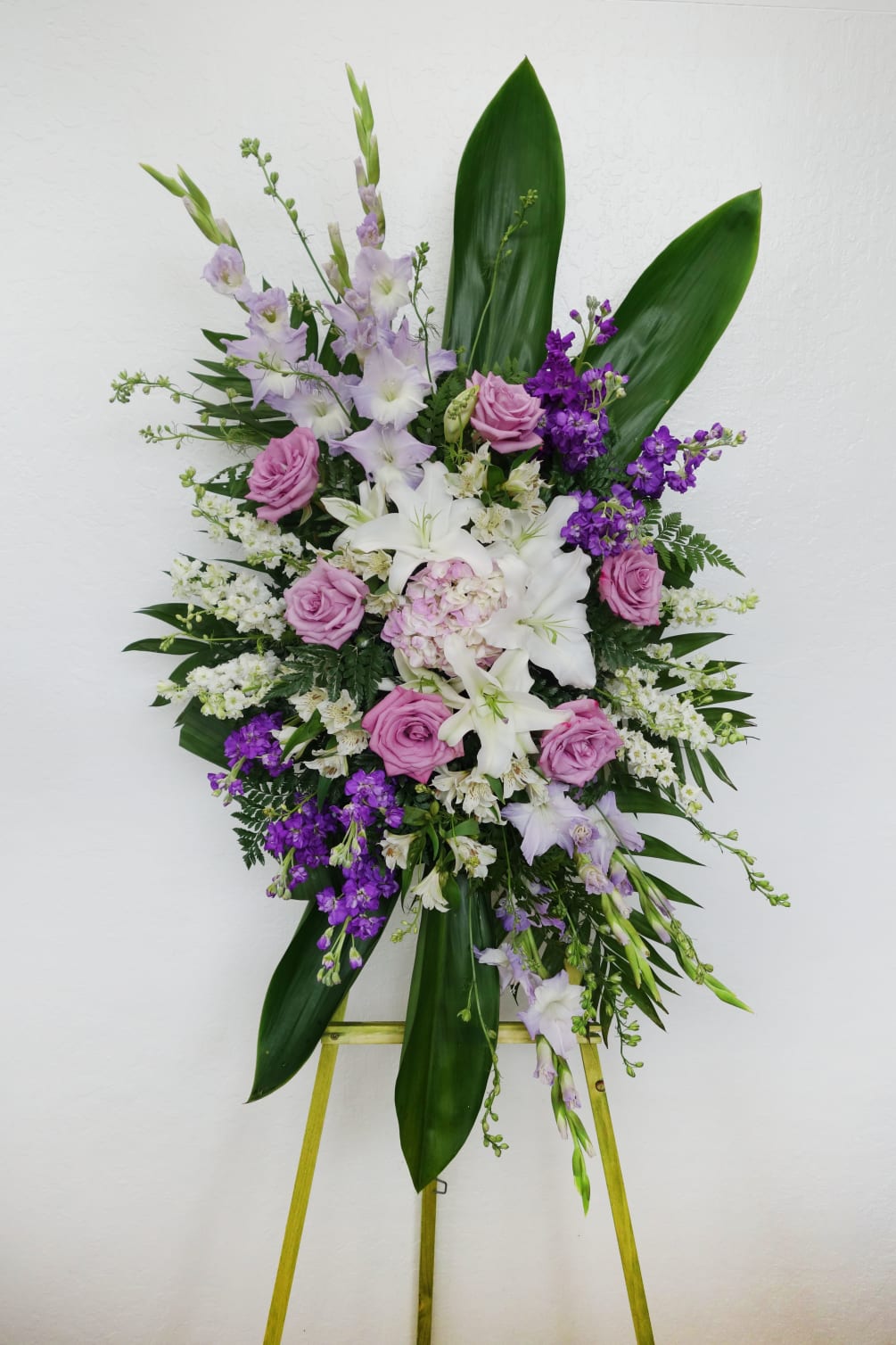 Send off loved ones with this bright and beautiful spray of lilies
