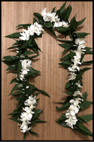 The beautifully classic maile style ti leaf lei intertwined single orchid lei.
