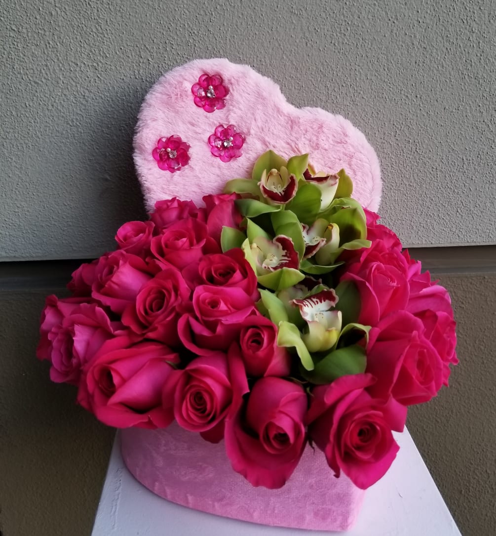 Pink roses and green orchids designed in a pink heart.