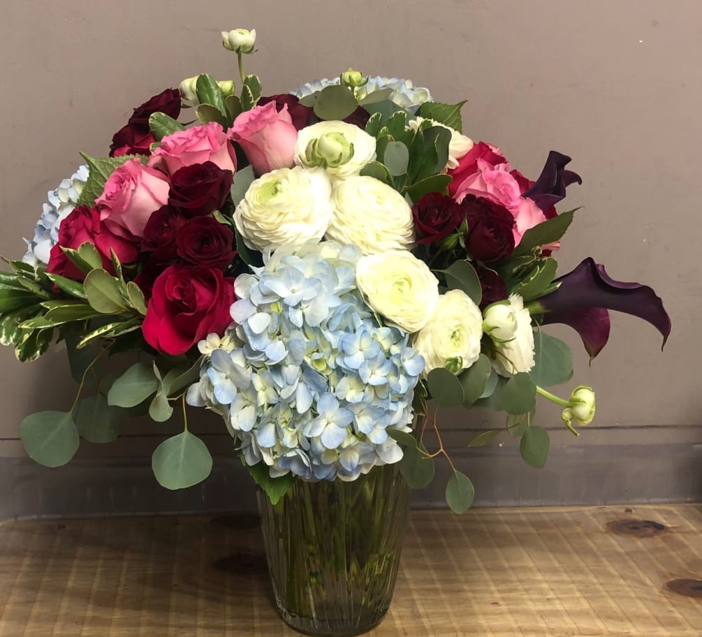 Make a bold statement with Ranunculus, Roses, Calla Lilies and Hydrangeas