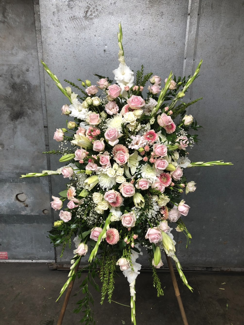 Roses, Gladiolas, Lilies, and Gerberas fill this Large Spray with an abundance