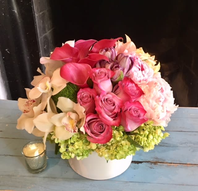 Beautiful mix of Tulips, Roses, Calla Lilies, Orchids, Hydrangeas in our signature