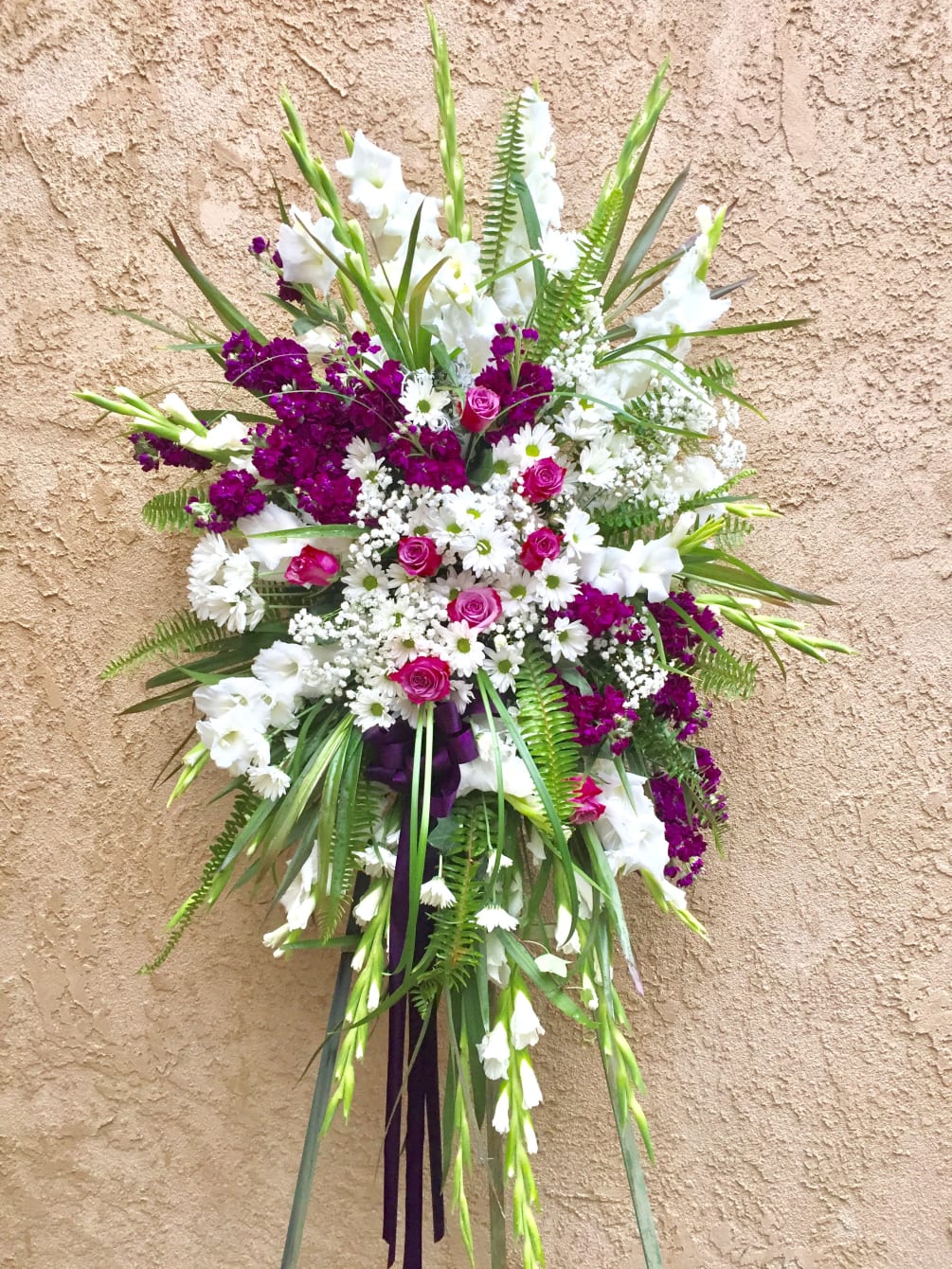 Funeral spray with purple and white fresh flowers