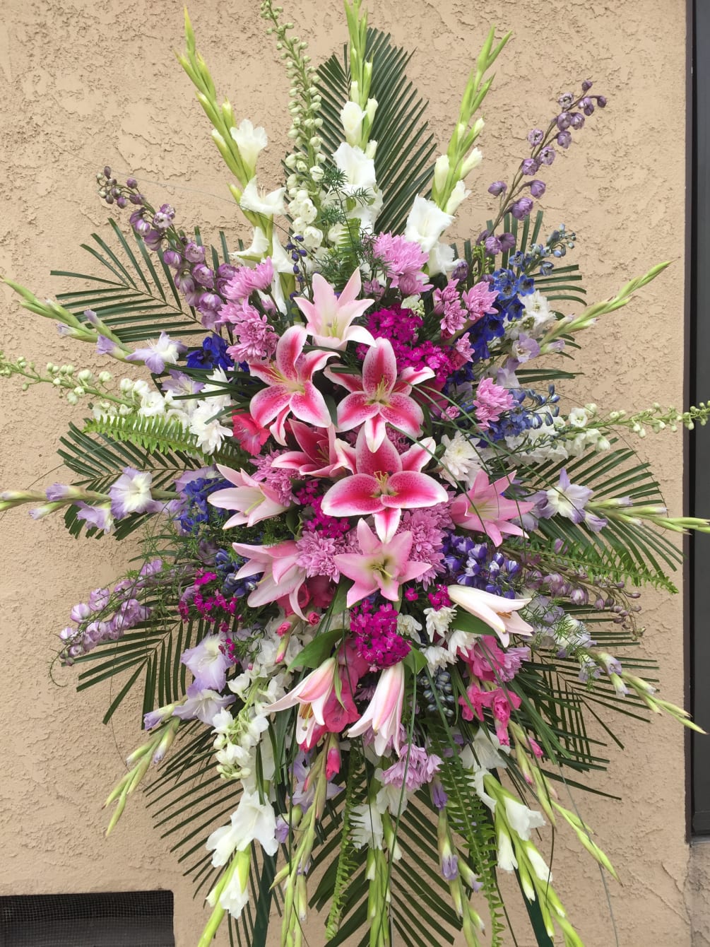 Standing spray with pink, purple and white flowers