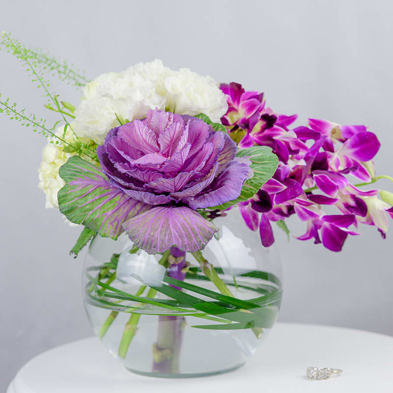 A splendid bouquet filled with gorgeous orchids, kale flower, and a beautiful