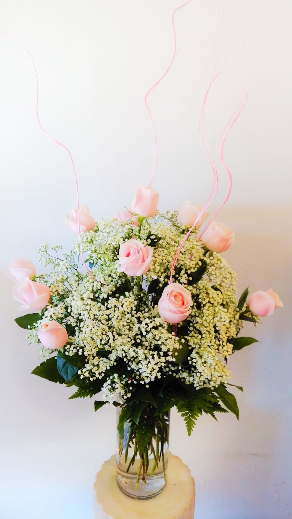 1 dozen pink roses elegantly arranged in a 5&quot; x 12&quot; cylinder