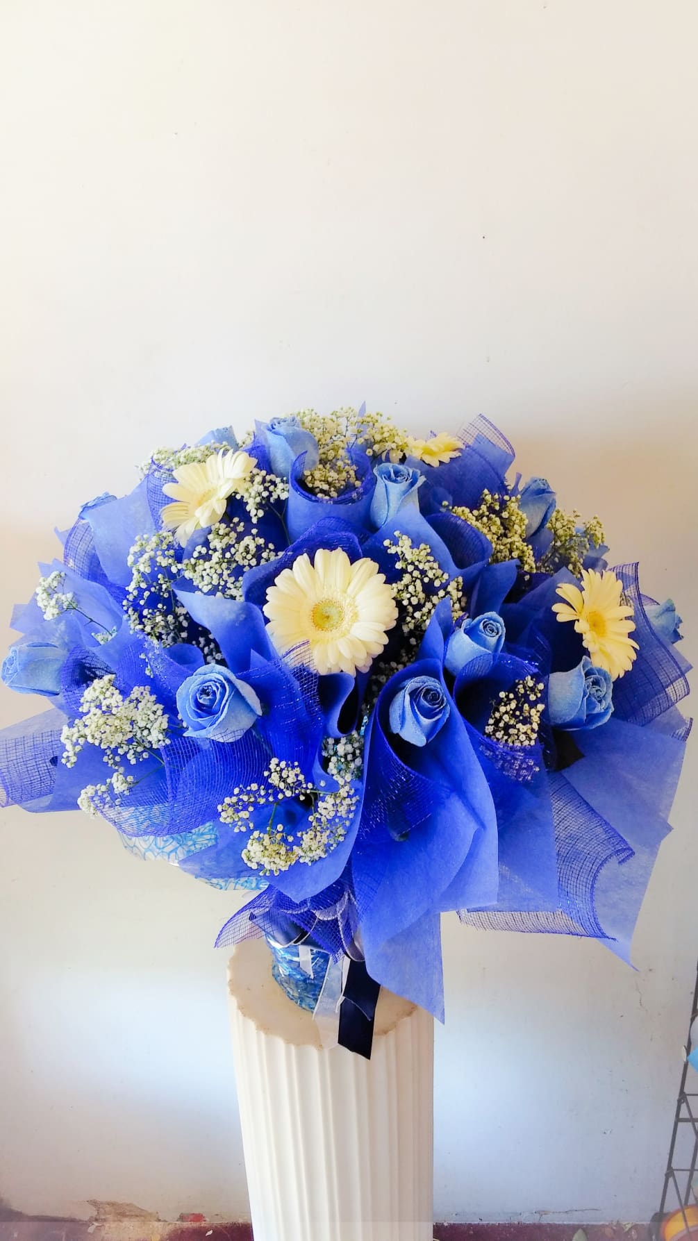 1 dz. blue roses with white gerbera daisy accents, elegantly wrapped Hong